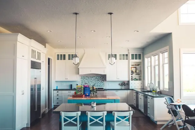 Photo with kitchen & dining room table, chair, cabinetry and refrigerator
