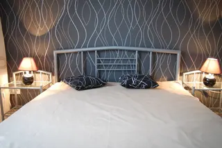 Photo with bed, pillow and lamp