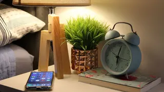 Video with lamp, pillow, plant and alarm clock