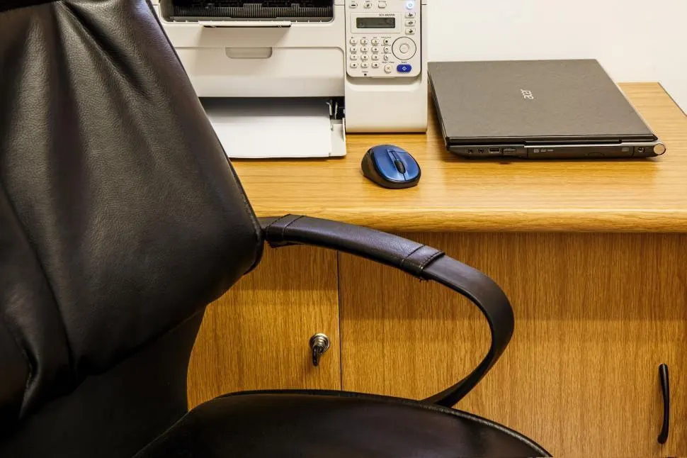 Photo with chair, printer and laptop