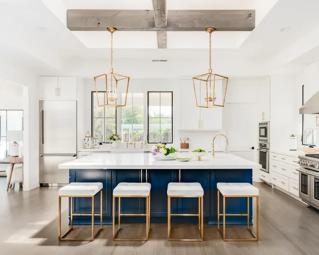 Photo with stool, cabinetry, oven and refrigerator