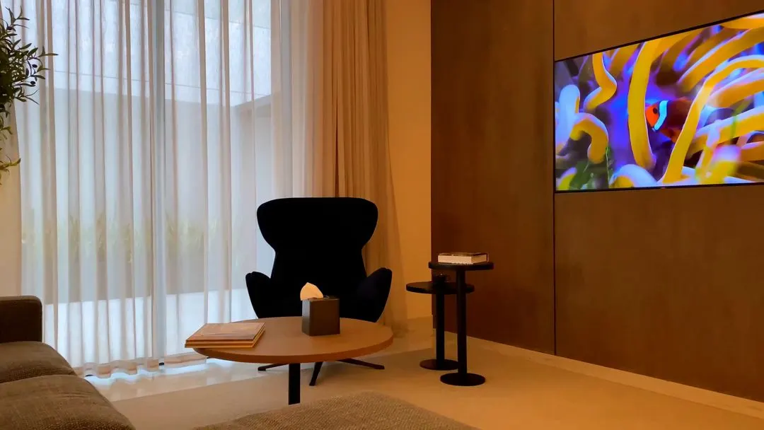 Video with curtains, tv, chair, desk, sofa and coffee table