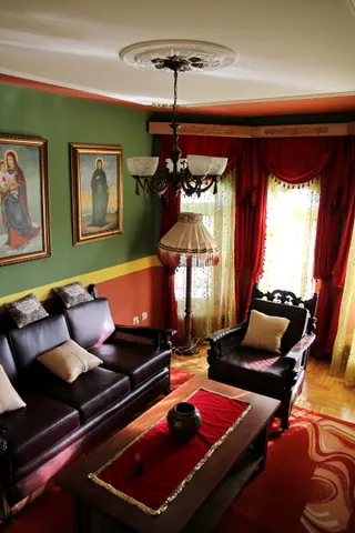 Photo with studio couch, chair, pillow, curtain, picture frame and carpet