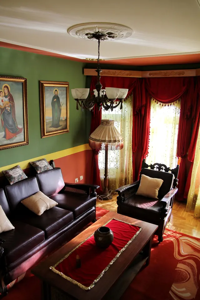 Photo with studio couch, chair, pillow, curtain, picture frame and carpet