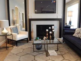 Photo with studio couch, coffee table, chair, lamp, pillow, television and carpet
