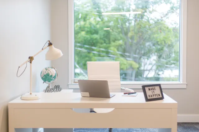 Photo with desk, chair, laptop, lamp, picture frame and window