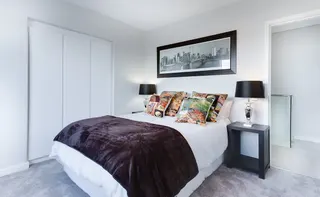 Photo with bed, nightstand, picture frame, pillow and lamp