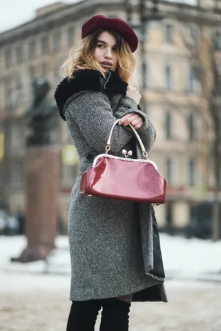 Photo with black leggings, coat, hat and handbag