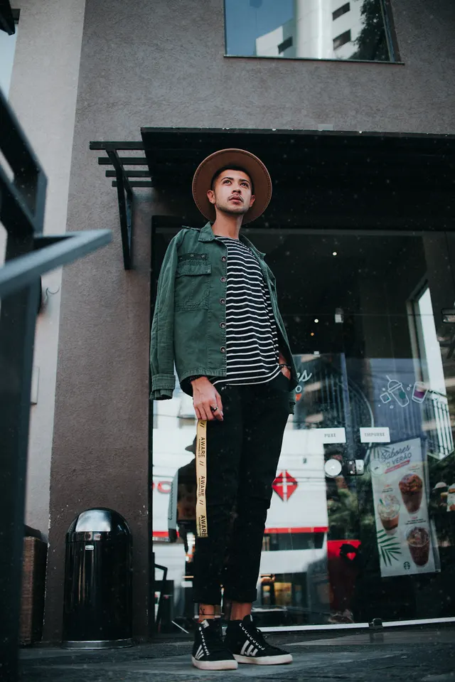 Photo with trousers, jacket, hat, sneakers and trash bin/can