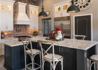 Photo with chair, cabinetry, kitchen appliance, lamp, refrigerator and countertop