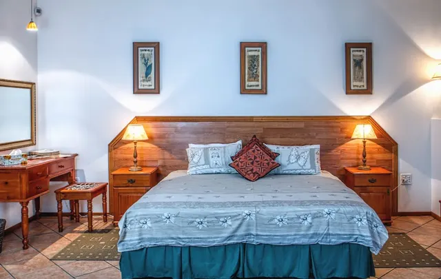 Photo with nightstand, stool, bed, picture frame, lamp and carpet
