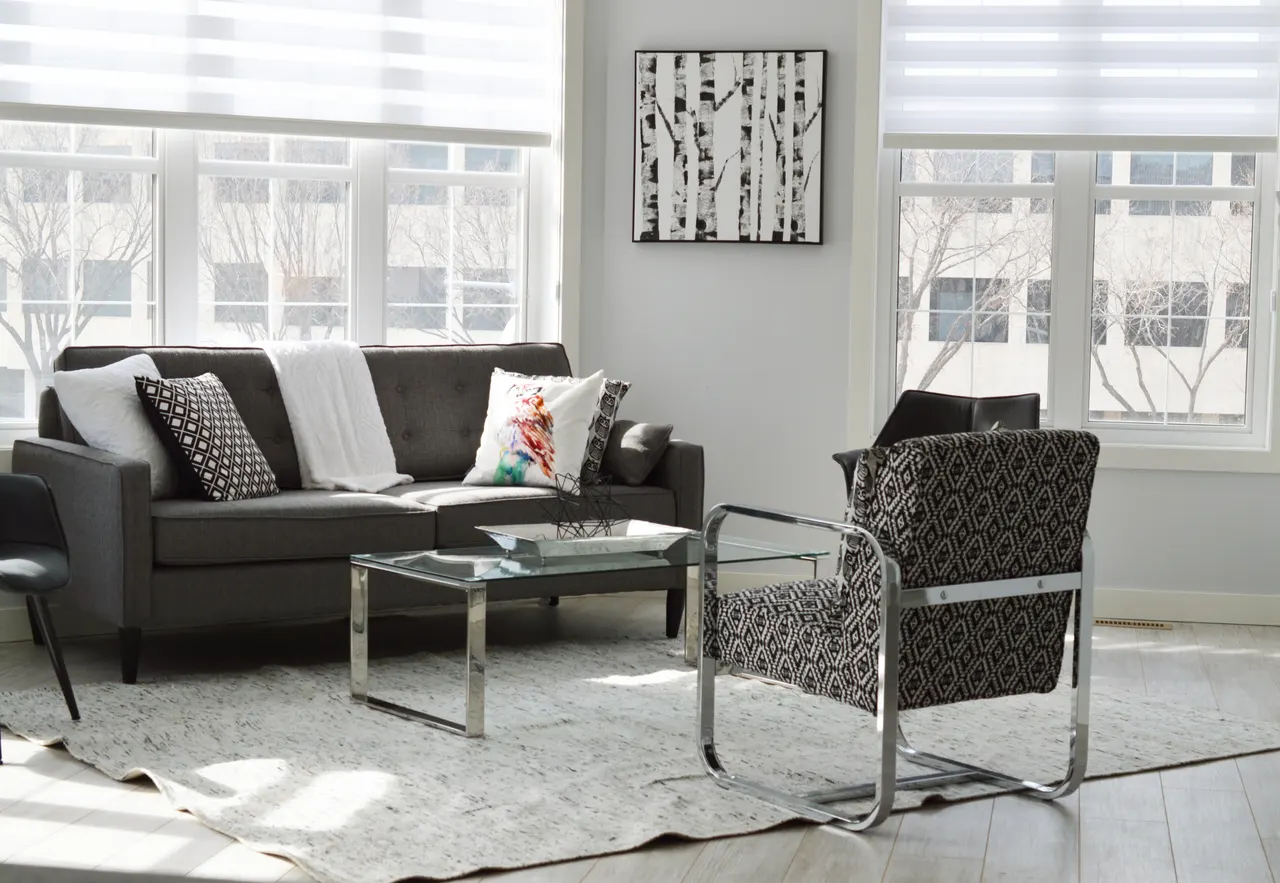 Photo with studio couch, chair, coffee table, pillow and window