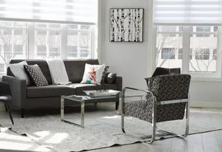 Photo with studio couch, chair, coffee table, pillow and window