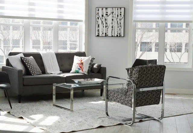 Photo with studio couch, chair, coffee table, pillow and window