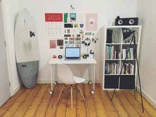 Photo with desk, cabinetry, loudspeaker, surfboard and lamp
