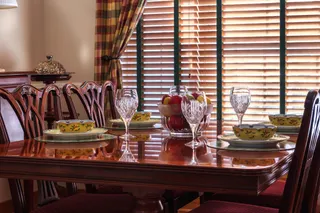 Photo with chair, desk, curtain, plate and wine glass