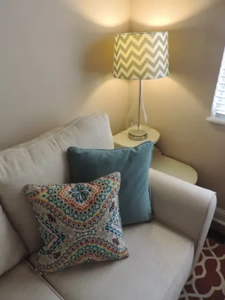 Photo with studio couch, lamp and pillow