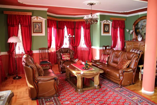 Photo with studio couch, chair, cabinetry, lamp and picture frame