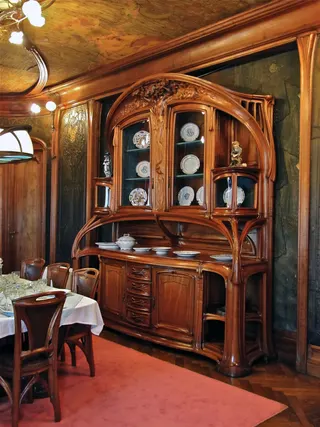 Photo with desk, cabinetry, lamp and carpet