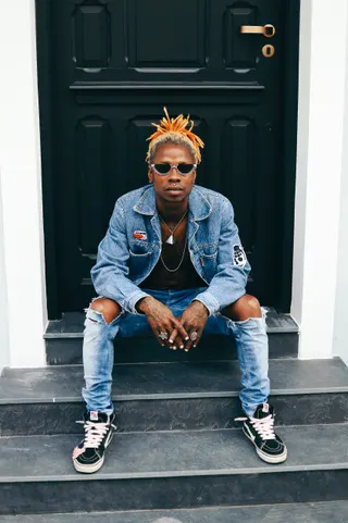 Photo with trousers, jacket, necklace, glasses and door