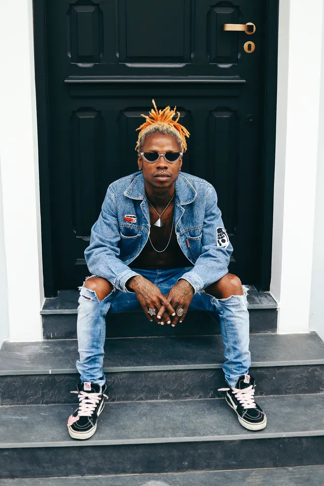 Photo with trousers, jacket, necklace, glasses and door