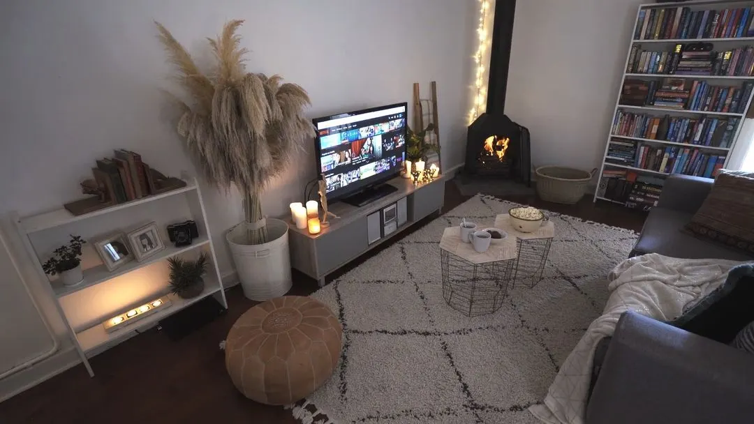 Video with cabinet, fireplace, plant, pillow, rug and desk