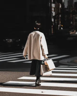 Photo with miniskirt, coat, high heels, handbag and glasses