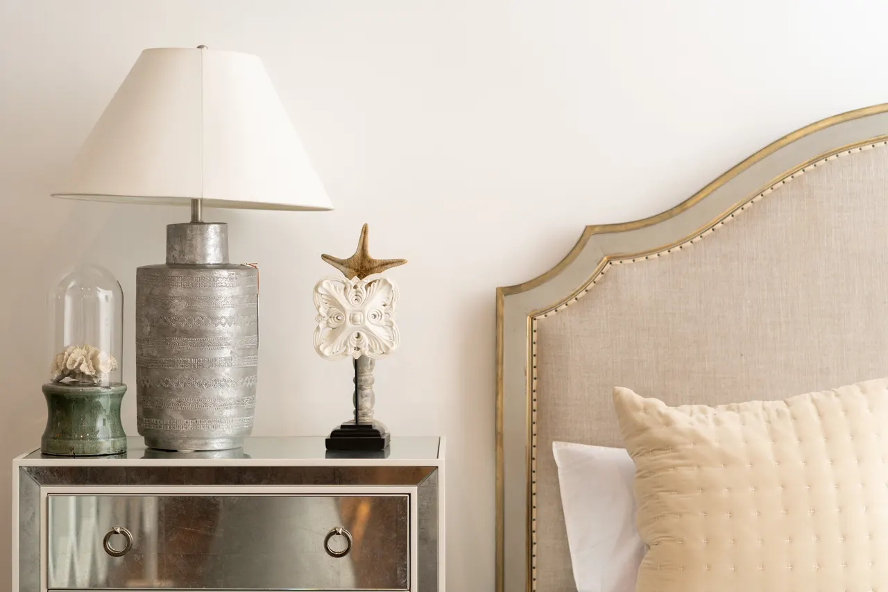 Photo with nightstand, bed, pillow and lamp