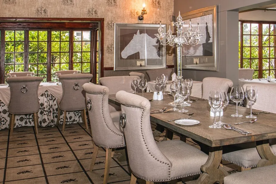Photo with desk, chair, lamp, picture frame, tablecloth and wine glass