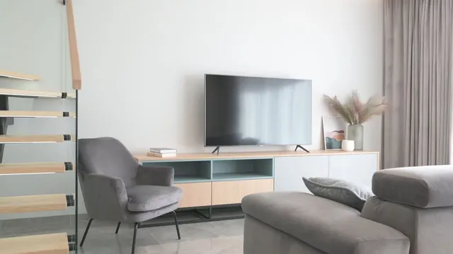 Video with cabinet, curtains, tv, plant, chair, sofa and pillow